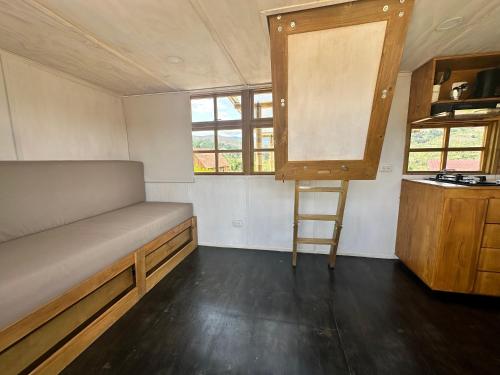 a small room with a bed and a ladder in it at KUYAY in Ráquira