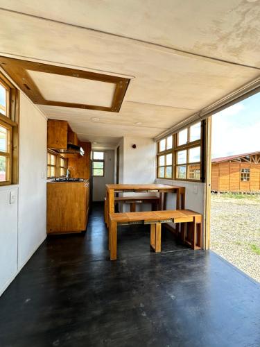 a kitchen and dining room of a tiny house at KUYAY in Ráquira