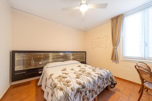 a bedroom with a bed and a large window at B&B Osteria dello sperone in Lonate Pozzolo