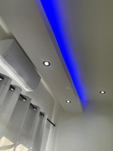 a ceiling with a blue light in a room at Esteem guesthouse Windhoek in Windhoek