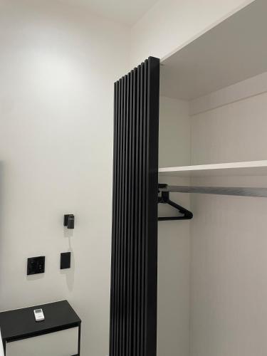 a white wall with a black radiator in a room at Esteem guesthouse Windhoek in Windhoek