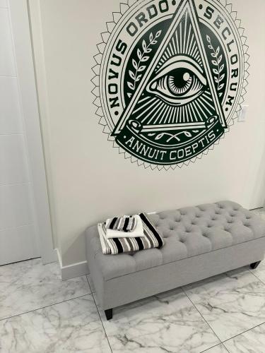 an all seeing eye wall sticker in a room with a couch at Illuminati Guest House in Victoria