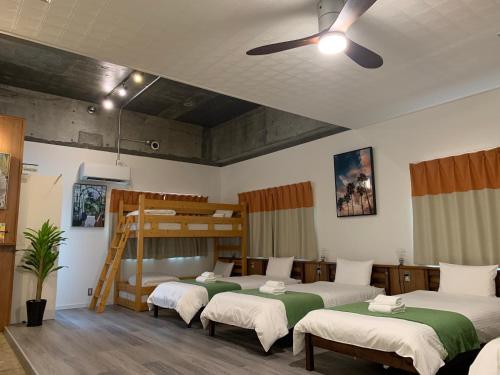 a room with four beds and a bunk bed at HAMBY101 in Chatan