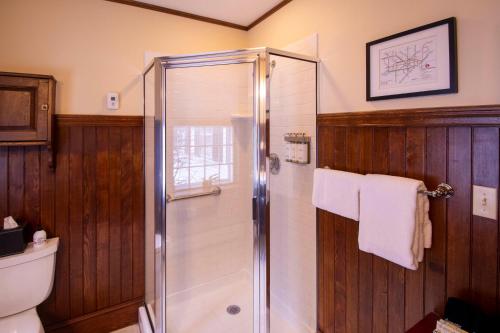 a bathroom with a shower and a toilet at Swift House Inn in Middlebury