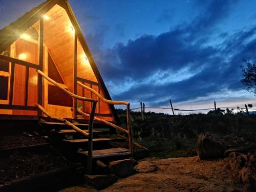 a staircase leading up to a house with a sunset at La madriguera de Guatavita Sta María in Guatavita