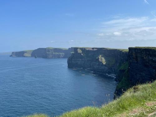 a large body of water with cliffs in the background at Swan Studio Haven in Lisdoonvarna