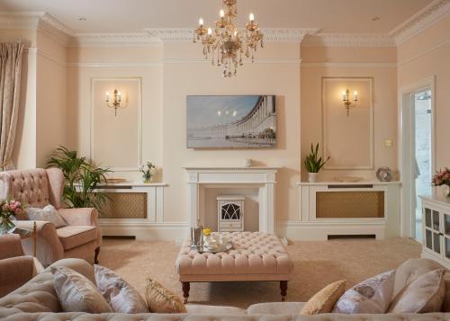 a living room with a fireplace and a chandelier at Bathen House Boutique Hotel in Bath