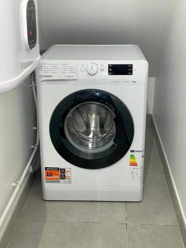 a white washing machine sitting in a room at Studio cosy proche Paris Orly in Morangis