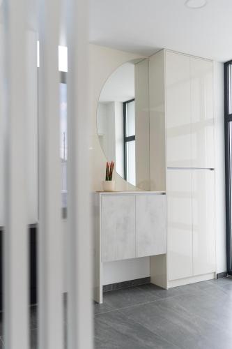 a bathroom with a white vanity and a mirror at Villa H in Blagaj