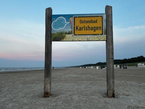 a sign on the beach in the sand at Hotel Ostseeblick - direkt hinter den Dünen in Ostseebad Karlshagen