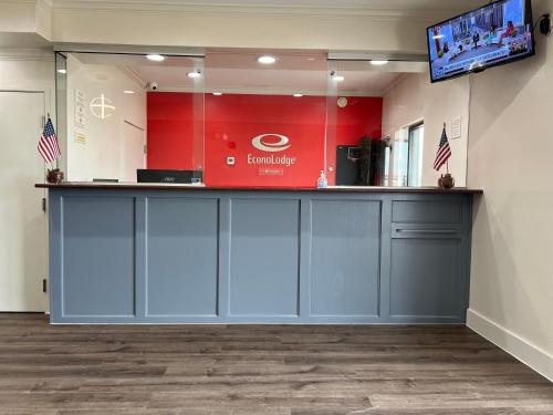 a lobby with a counter and a tv in a room at Econo Lodge Beaumont I-10 South in Beaumont