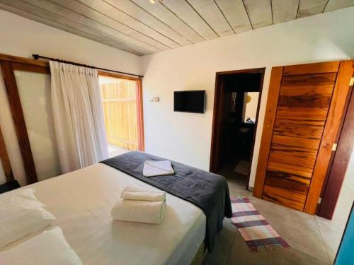 Säng eller sängar i ett rum på Reserva Ilhabela