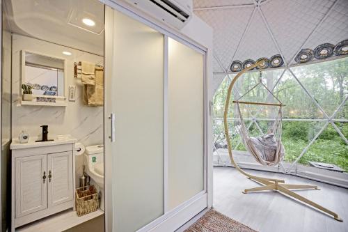 a bathroom with a shower with a glass door at Dream Dome Getaway near Leesburg in Leesburg