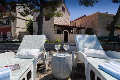 two chairs and a table with wine glasses on a patio at Villa Nauta in Lovište