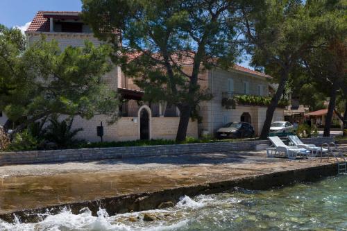 a house sitting next to a body of water at Villa Nauta in Lovište