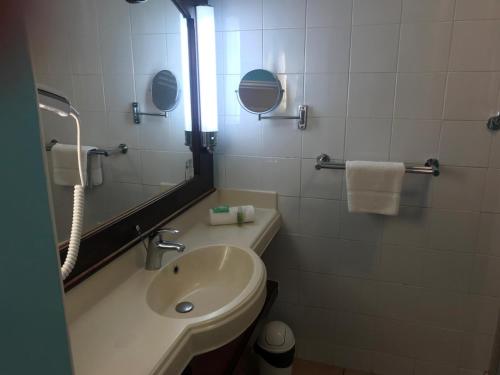 a bathroom with a sink and a mirror at la Désirade in Sainte-Luce