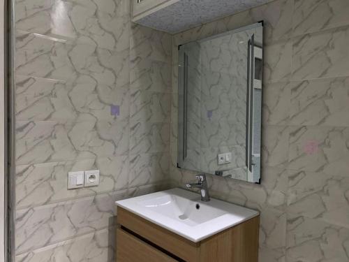 a bathroom with a sink and a mirror at Your Hideaway Perfect for Work or Leisure! in Rabat