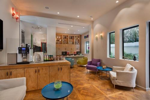 a living room with two tables and chairs at Cucu Hotel in Tel Aviv