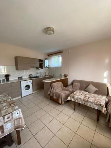 a living room with a couch and a kitchen at MARY in Stepʼanavan