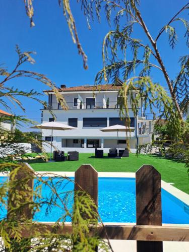 an external view of the house and the pool at ArouceHostel in Lousã