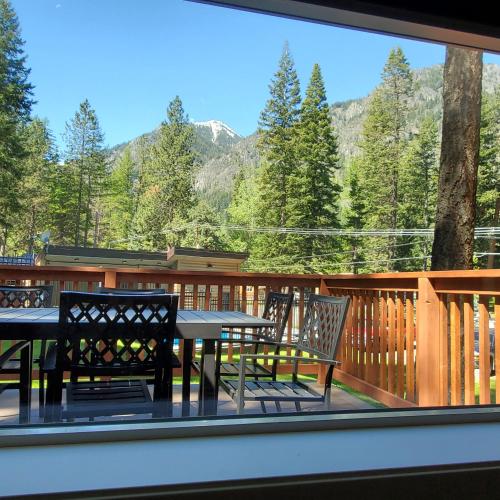 a patio with a table and chairs on a deck at Eagle Cap Chalets in Joseph