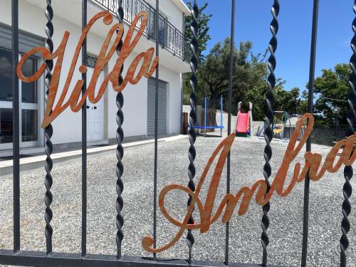a sign on a gate in front of a building at Villa Ambra Sicilia in Librizzi