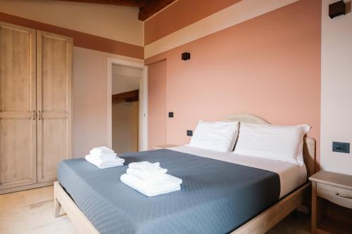 a bedroom with a bed with towels on it at Terrazza sulle mura in Predore