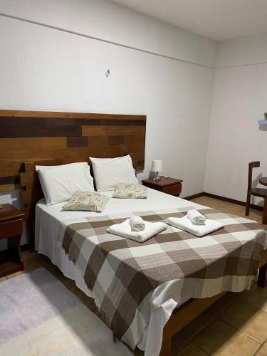 Ένα ή περισσότερα κρεβάτια σε δωμάτιο στο Pousada Villa Flamboyant