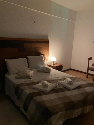 Ένα ή περισσότερα κρεβάτια σε δωμάτιο στο Pousada Villa Flamboyant