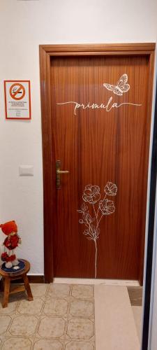 a wooden door with a sign on it at Via Castello Appartamento da Mary in Montecreto