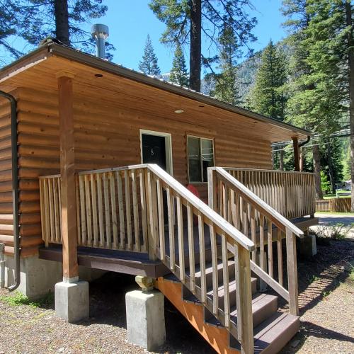 a log cabin with stairs leading to the door at Eagle Cap Chalets in Joseph