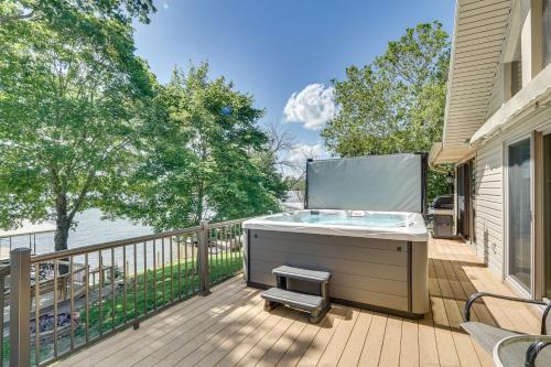 a hot tub on the deck of a house at Retreat with Dock and Views in Lake of the Ozarks in Laurie