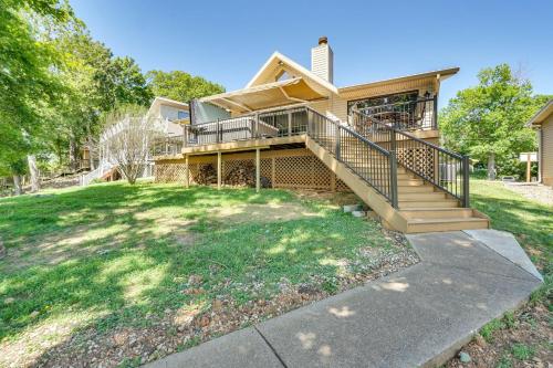 a house with a staircase in front of a yard at Retreat with Dock and Views in Lake of the Ozarks in Laurie