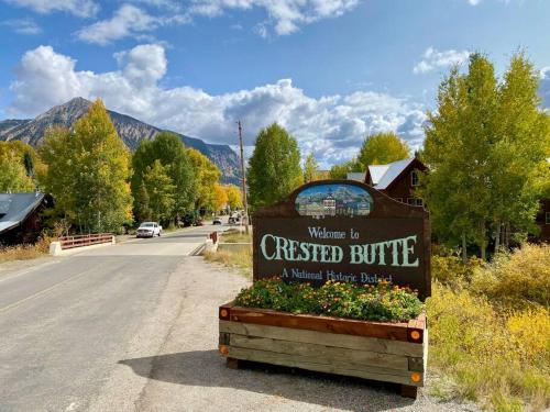 a sign for aumed buffet building on the side of a road at MT CB Mountain Side with King Bed, Hot Tub, Pool & Kitchen! in Crested Butte