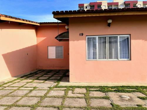 a house with a window on the side of it at Praia Martin de Sá SP. in Caraguatatuba