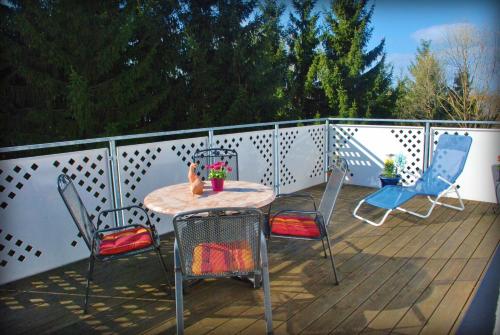 a patio with a table and chairs on a deck at Ferienwohnung Walker in Neudingen