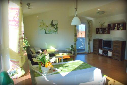 a living room with a table and a couch at Ferienwohnung Walker in Neudingen