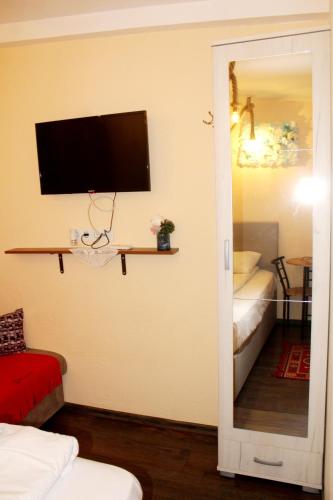 a room with a tv on the wall and a doorway at Sebilhan Apart Hotel in Sarajevo