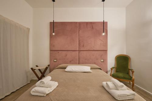 a bedroom with a bed with two towels on it at Makó House - in centro città in Andria
