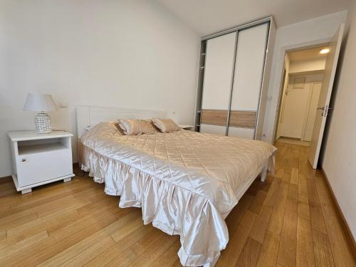 a bedroom with a bed and a table and a mirror at Apartment S&M in Banja Luka