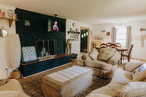 a living room with a couch and a fireplace at Dolly House in Sevierville