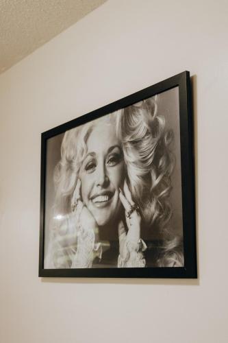 a black and white picture of a woman on a wall at Dolly House in Sevierville