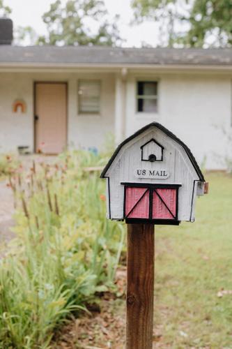 a us mail mailbox on a wooden pole in front of a house at Dolly House in Sevierville