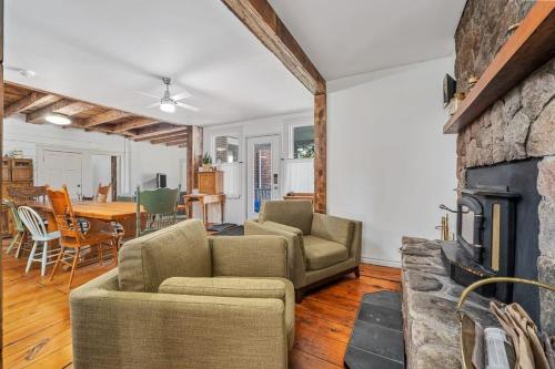 a living room with a couch and a fireplace at The Marigold PEC Family Farmhouse country escape in West Lake