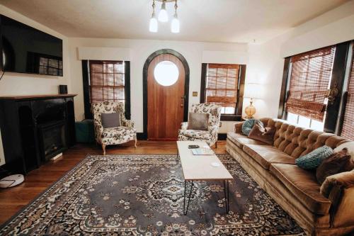 a living room with a couch and a fireplace at Fairy House by Eden Crest in Sevierville