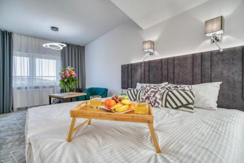 Ένα ή περισσότερα κρεβάτια σε δωμάτιο στο Acodomo Apartamenty