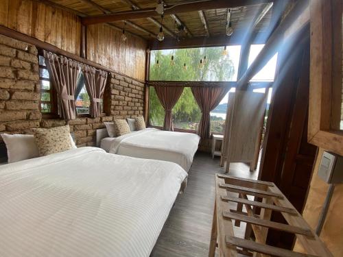 een kamer met 3 bedden en een raam bij Cabaña Isla Dorada in Guatavita