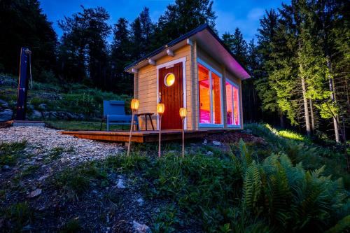 a small cabin in the woods at night at Sonnenhäusle - Natur. Fernblick. Panorama-Sauna. in Sasbachwalden