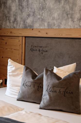 a bed with two pillows on top of it at klein&fein in Neustift im Stubaital
