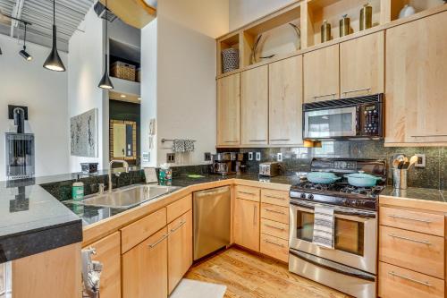 a kitchen with wooden cabinets and stainless steel appliances at Near Trail Dtwn Eagle Ranch Condo with Balcony in Eagle